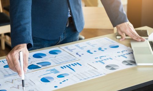 Team work process. young business managers crew working with new startup project. labtop on wood table, typing keyboard, texting message, analyze graph plans.